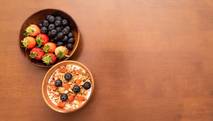 fresh cereal and milk with strawberry and blueberry in bowl, Copy space on the right