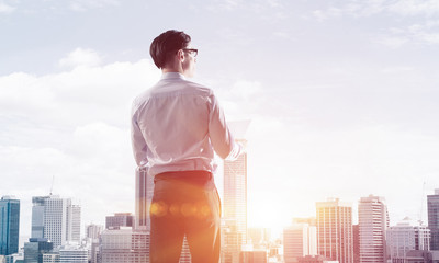 Concept of business success and control with confident boss against cityscape background