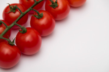 Cherry tomato bunch closeup isolated on white background.
