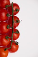Fresh cherry tomato, close-up, isolated on white background.