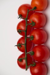 Fresh cherry tomato, close-up, isolated on white background.
