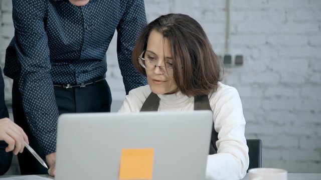 Mature woman working with employee manager man on new startup pr