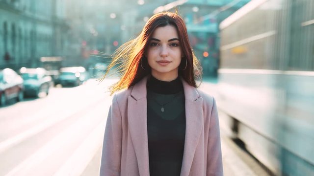 serioes bussineswoman stand in street fast moving timelapse cars, busy traffic, lost time look camera