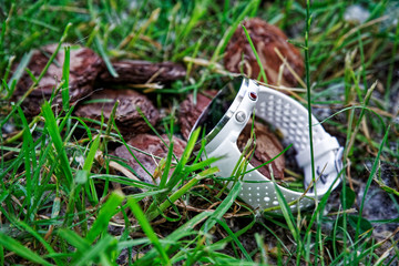 Sport watch for running white color on the ground in the grass. Fitness watch for tracking daily activity and strength training.