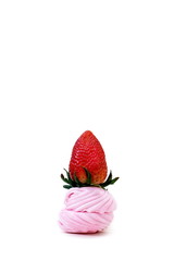 strawberry is on the pink marshmallows on a white background