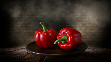 Red pepper on a wooden table, dark room, dark background