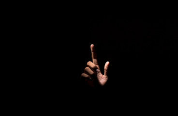 Empty hand pointing finger on black dark background