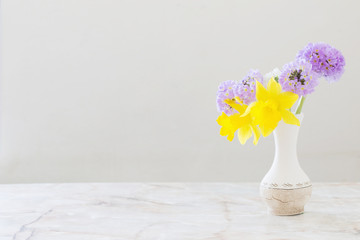 spring flowers in vase on marble table