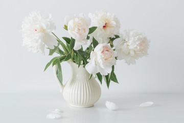 peonies flowers in vase on white background
