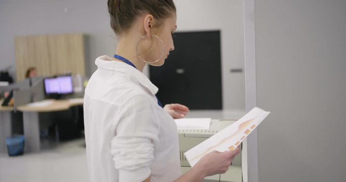 Businesswoman using a printer.