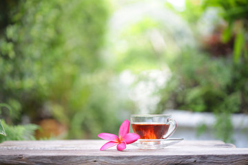 cup of tea with small flower  and notebooks 
