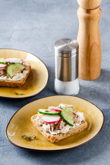 Delicious tuna sandwich, served with radish and cucumber