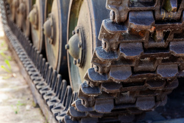 Close-up of a tank (caterpillar howitzer) caterpillars with wheeled rollers of a heavy tank