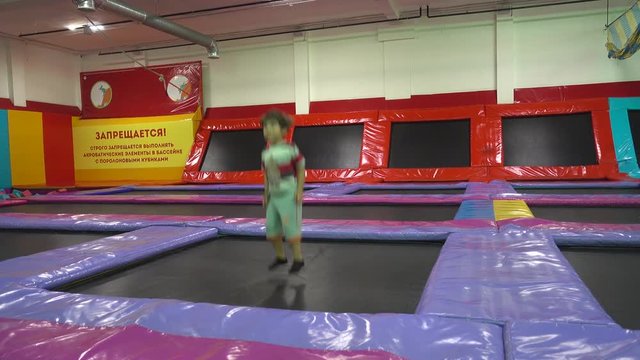 Kherson, Ukraine - 17th of June 2018:  4K Fabrica intertainment center - Child bounces on huge trampoline 
