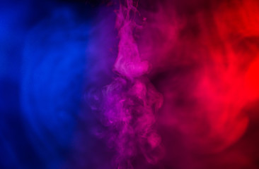 fusion of blue and red smoke in motion isolated on black background