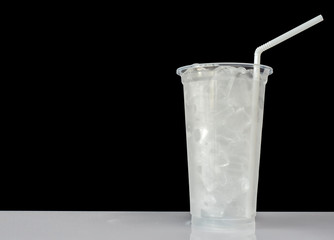 Ice in a glass made of plastic On a black background