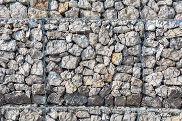 Stone wall with metal grid as background
