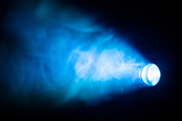 blue spotlight from circle light bulb projector shine beam for movie and cinema in abstract smoke texture . glowing screening for multimedia production , knowledge and education futuristic concept .