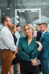 Obraz premium young beautiful woman on a background of colleagues in the office