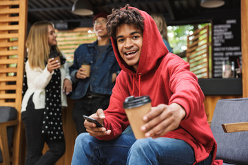 Smiling african teenager sitting outdoors