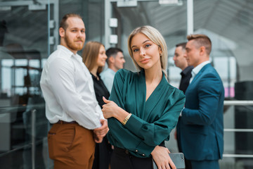 young beautiful woman on a background of colleagues in the office