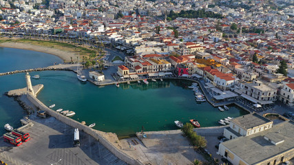 Fototapeta premium Aerial drone photo of unique old picturesque Venetian port with old lighthouse in the heart of famous city of Rethymno, Crete island, Greece