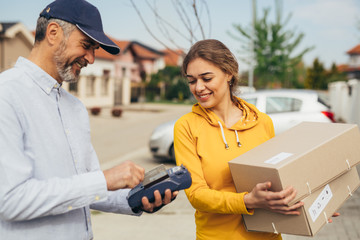 woman paying with visa or master card for post express service