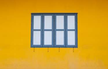 Old wooden windows, classsic retro style, white-green colour with yellow wall.