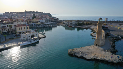 Fototapeta premium Aerial drone photo of unique old picturesque Venetian port with old lighthouse in the heart of famous city of Rethymno, Crete island, Greece