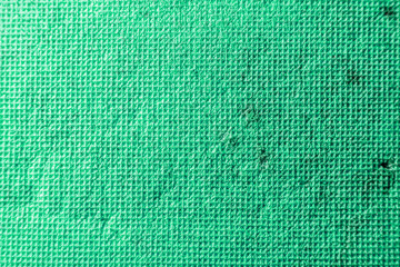 Bright green texture consisting of small squares with scratches and scuffs