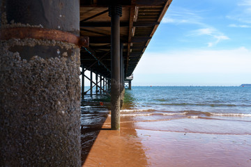 sea pier in english riviera with beach and blue sky.