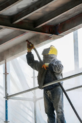 Sand blasting process  Industial worker using sand blasting process preparation cleaning surface on steel before painting