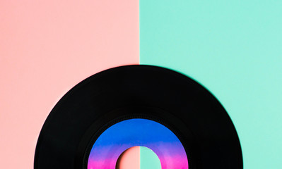 vinyl gramophone disc at trendy pink and green background
