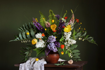 still life with a bouquet of garden flowers and a shell