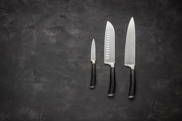 Set of Kitchen Knives on Stone Background