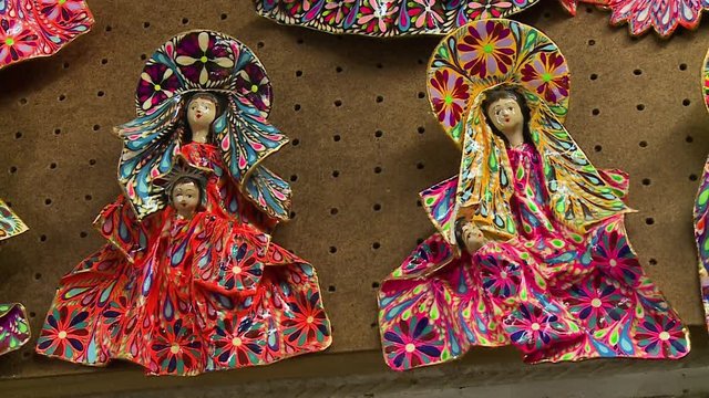 Close-up still shot of a doll of mother and child with colourful and creative clothing design, San Blas, Cusco