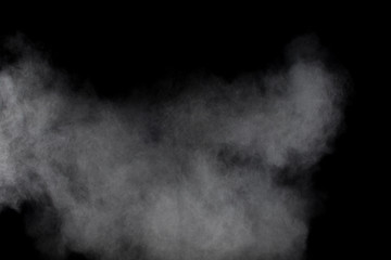 White powder explosion cloud against black background.White dust particles splash.