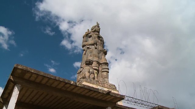 Close-up low-angle  side view still shot of an old sculpture of Pachacutec, the Inca King, Cusco, Peru
