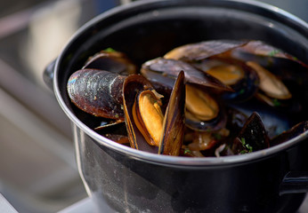 Seafood in Saucepan, mussels. italian restaurant cuisine, healthy delicatessen food. Street market, street trading, healthy food.