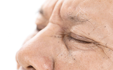 close-up of elderly asian man eyes with wrinkle on face