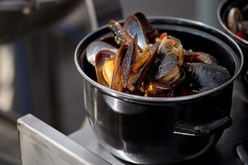 Seafood in Saucepan, mussels. italian restaurant cuisine, healthy delicatessen food. Street market, street trading, healthy food.