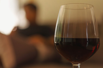 Glass of red wine on table in house. relaxing at home concept.