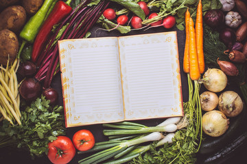 Vegetarian Raw Food Recipe. Blank Empty Cook Book Mockup with Fresh Vegetables. Healthy Eating Concept with Copy Space.