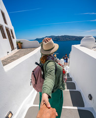 Couple Traveling. Woman holding hand with Man and leading the Way to New Places