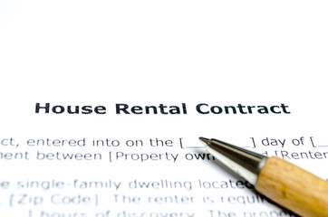 House rental contract with wooden pen