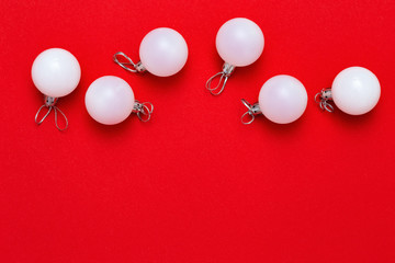Christmas decoration, Same white balls close up on red background with copy space. New Year and winter Holiday concept. Flat lay. Top View.
