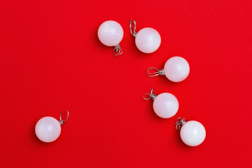 Christmas decoration, Same white balls close up on red background with copy space. New Year and winter Holiday concept. Flat lay. Top View.