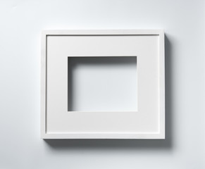 Empty white wood frame with shadow on white background
