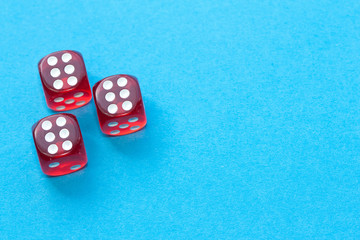 Red dices on blue background.