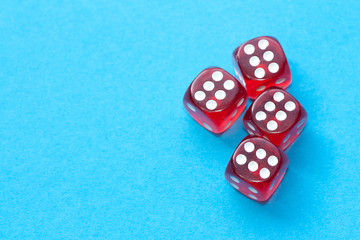 Red dices on blue background.